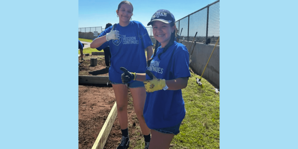 students in the ywla garden with tools and gardening