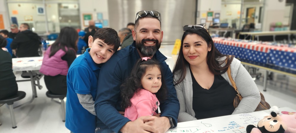 Family poses for a picture on Veterans Day Celebration.