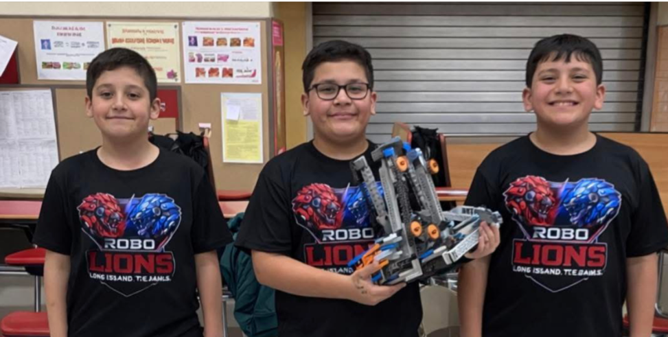 Students holding a robot