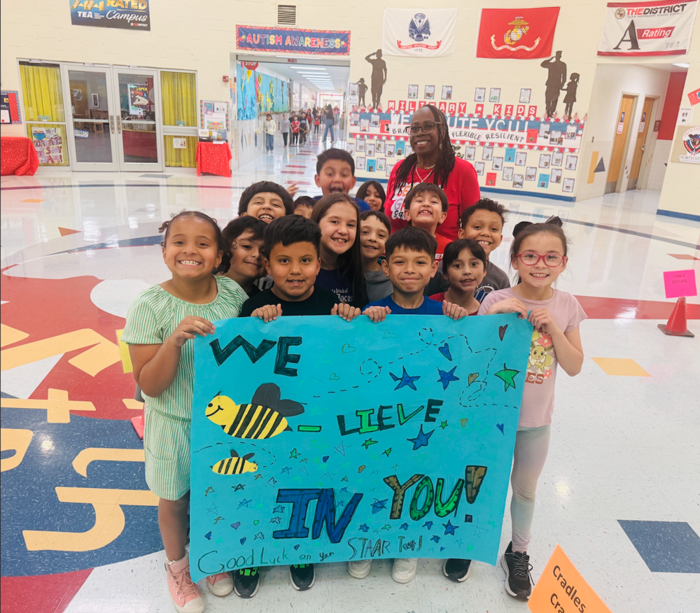 students holding motivational sign