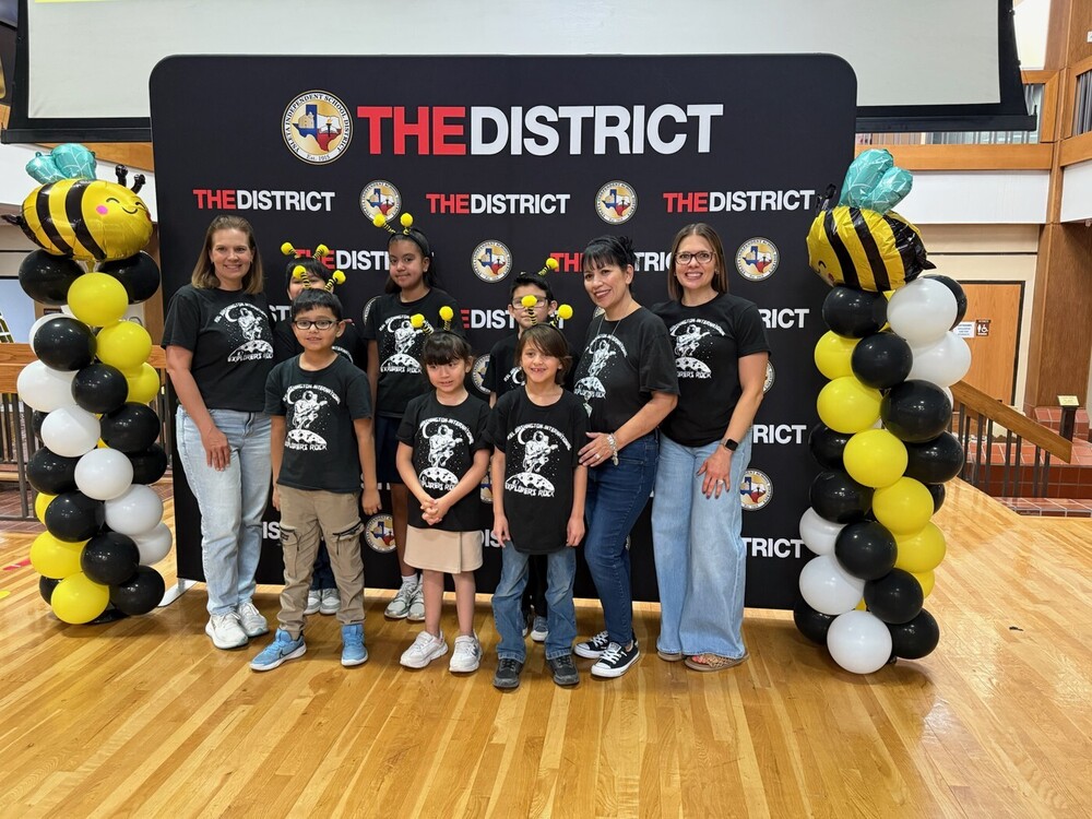 Math bee participants posing with their sponsors at the Math Bee district competition