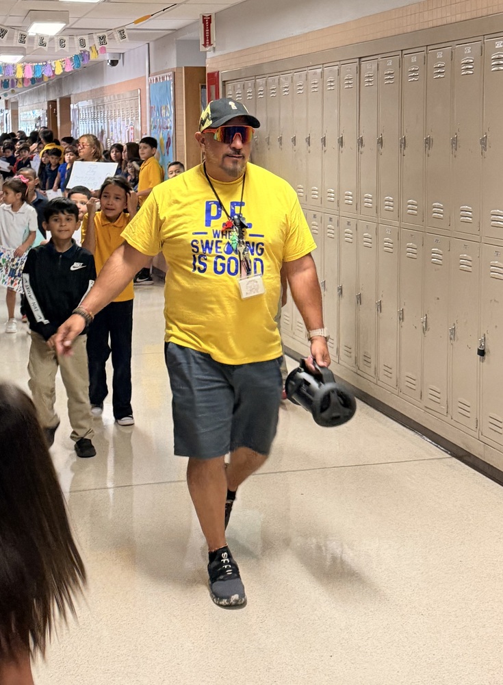 Coach Rico walks the halls at EHES one last time.