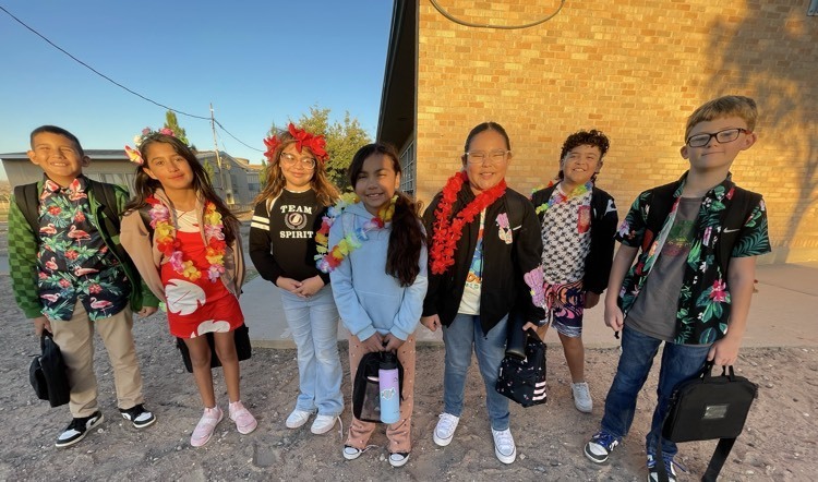 Students wearing leis & Hawaiian attire.