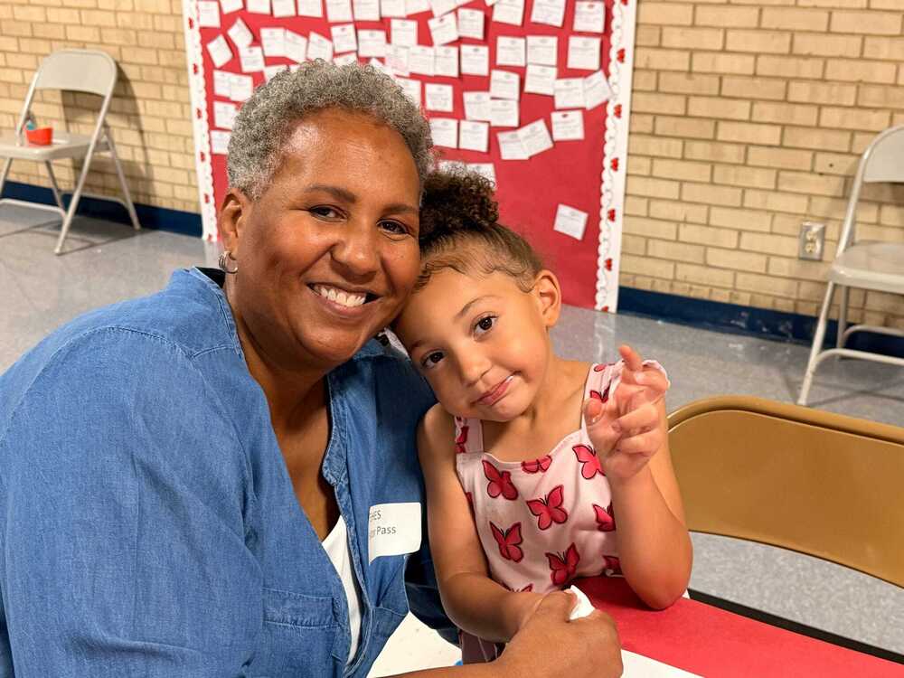 Girl and her grandma pose for a picture