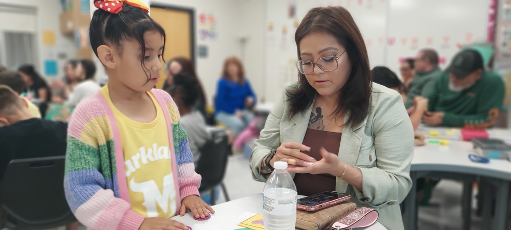 A female student and her grandmother are doing an activity in class together.