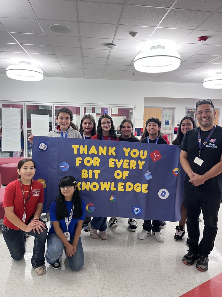 Mr. Gomez our Instructional Technology Coaching posing for a photo next to the Student Council class on National IT Professionals Day.