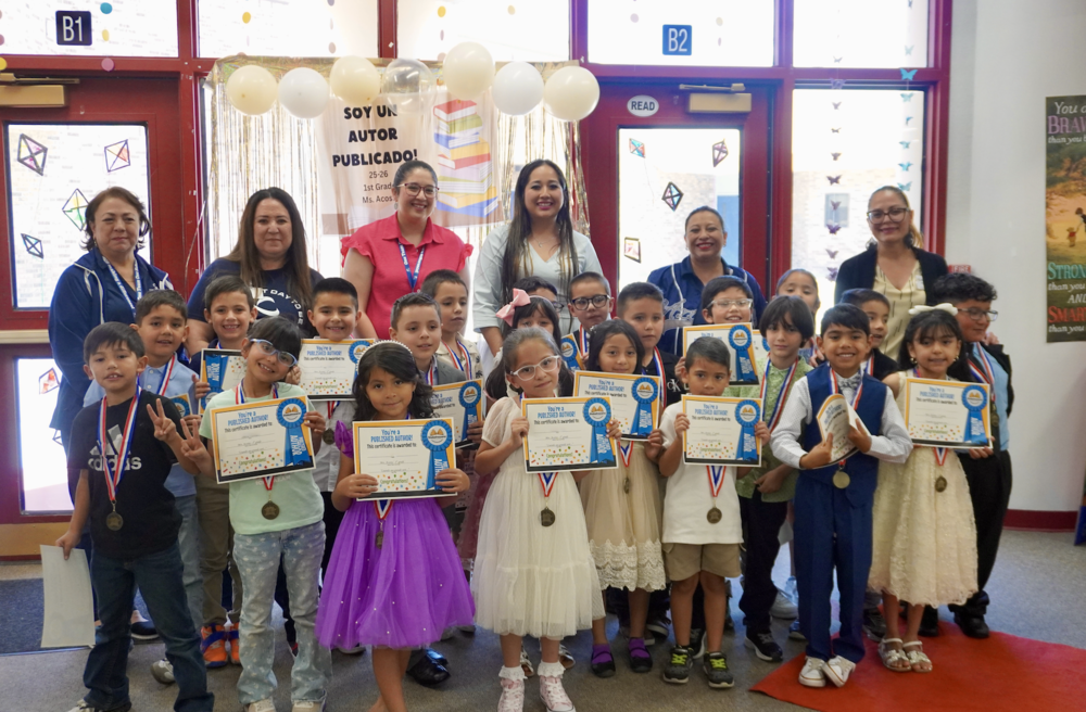 Lancaster Aztec students taking a picture with their certificates at their book signing.