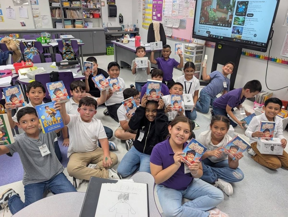 A classroom of students holding books. 