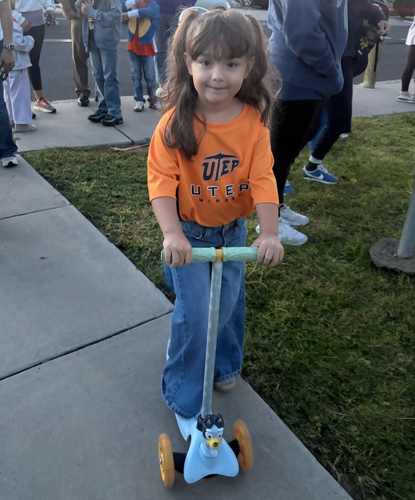 Student rides her scooter to school.