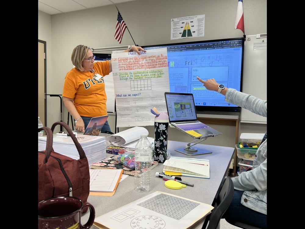 teacher holding up a poster