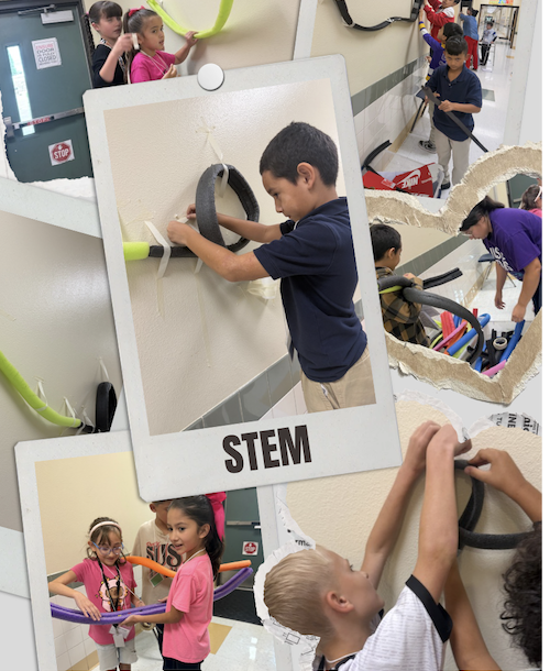 Students taping foam to the wall to create a roller coster for a marble