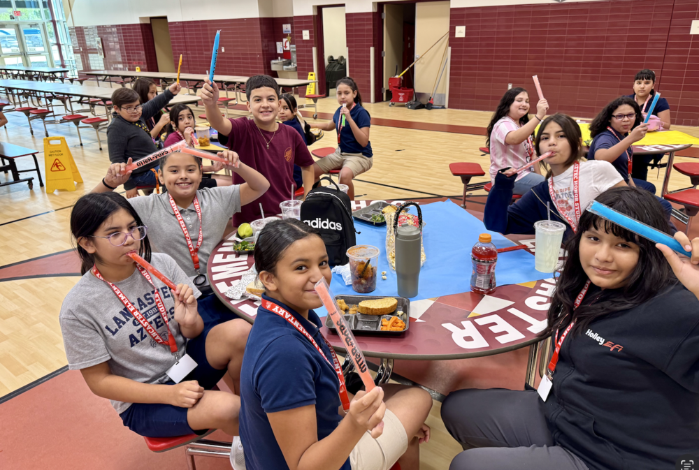 Students eating a frozen treat in the cafeteria.
