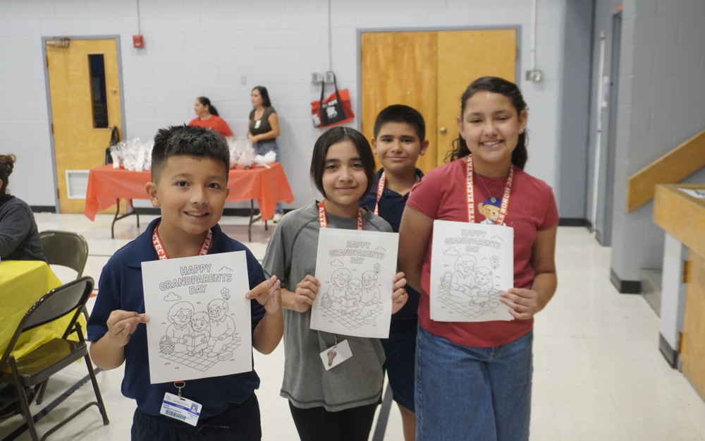 Aztecs showing their coloring pages on grandparents day.