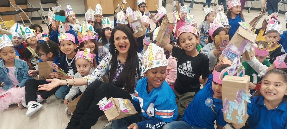 Author Lisa Caprelli poses for a picture with Dolphin Terrace students.