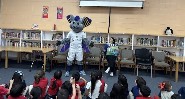 Ozzy the mascot from the Locomotive visits Presa to Join in America Read Aloud