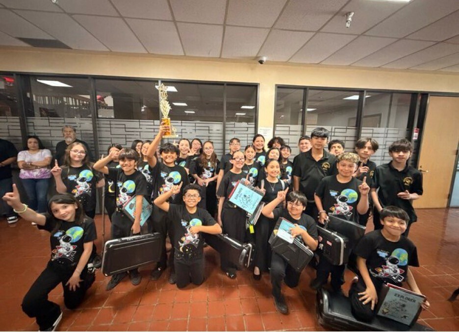 band students holding their trophy andcelebrating their Superior Rating at the YISD young band festival