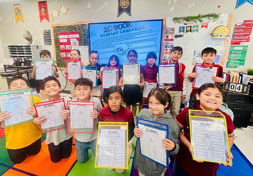 students holding their reading log 