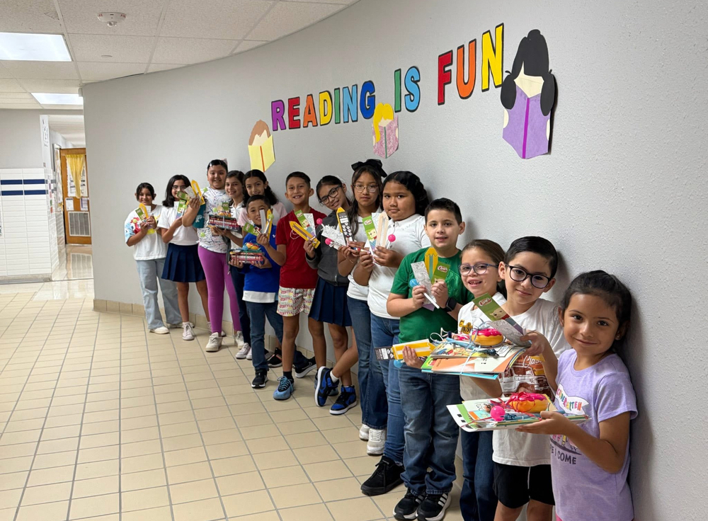 students showing book prizes