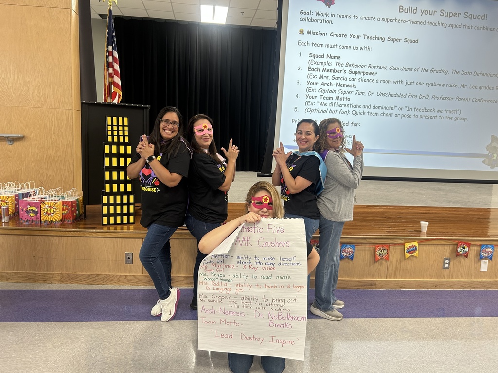 Third  Grade teachers holding Super Power Poster