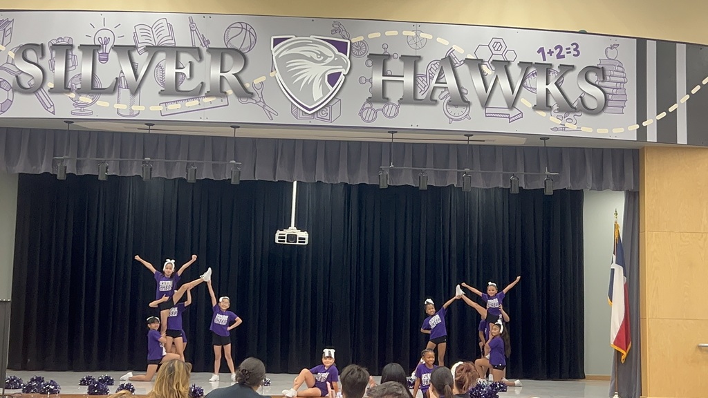 Desertaire Cheerleaders cheering on stage for teachers,