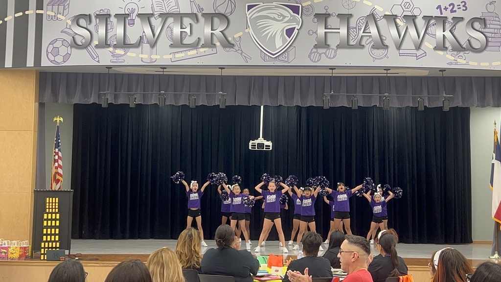 Desertaire Cheerleaders cheering on stage for teachers,