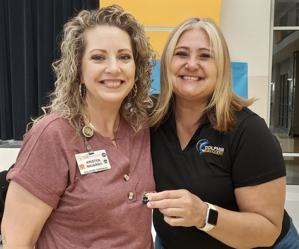 Assistant Principal and teacher pose for a picture