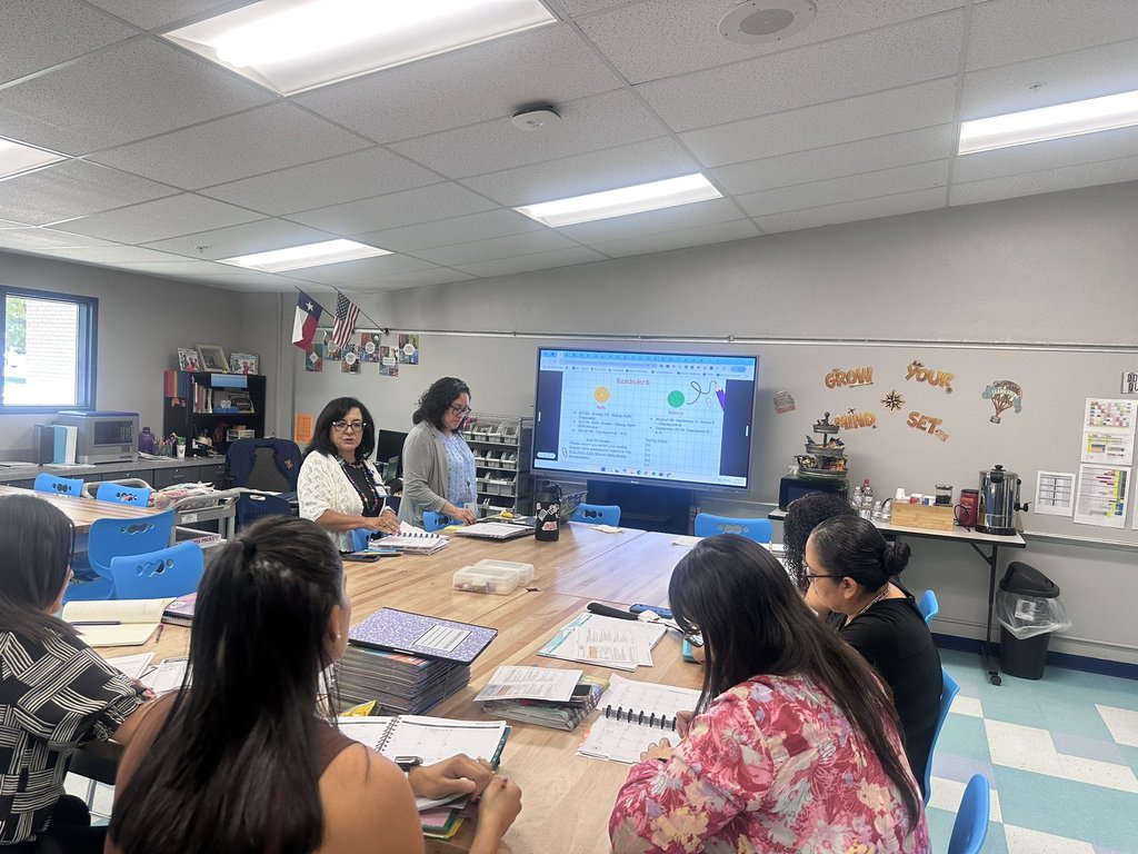 Photo of EKIS teachers getting information and preparing for the new year at a PLT meeting.