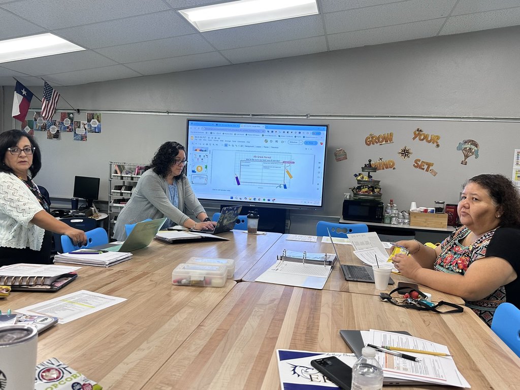 Photo of EKIS teachers getting information and preparing for the new year at a PLT meeting.