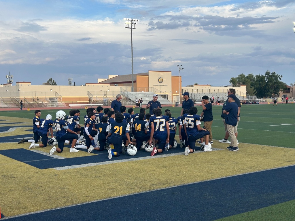 Photo of EKIS football players in a pre-game huddle.