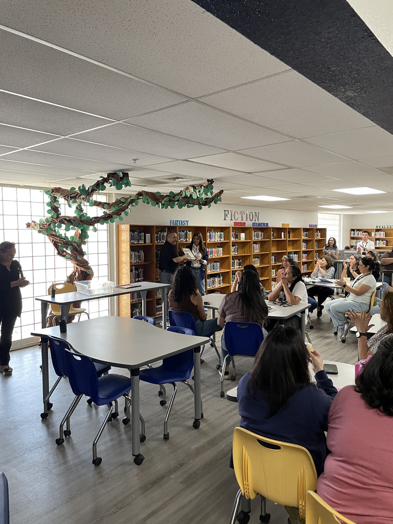 Photo of Ms. Granado receiving the Teacher of the Month recognition.