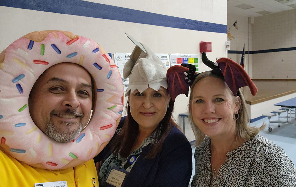 Photo of EKIS Principal and Assistant Principals wearing crazy hats.