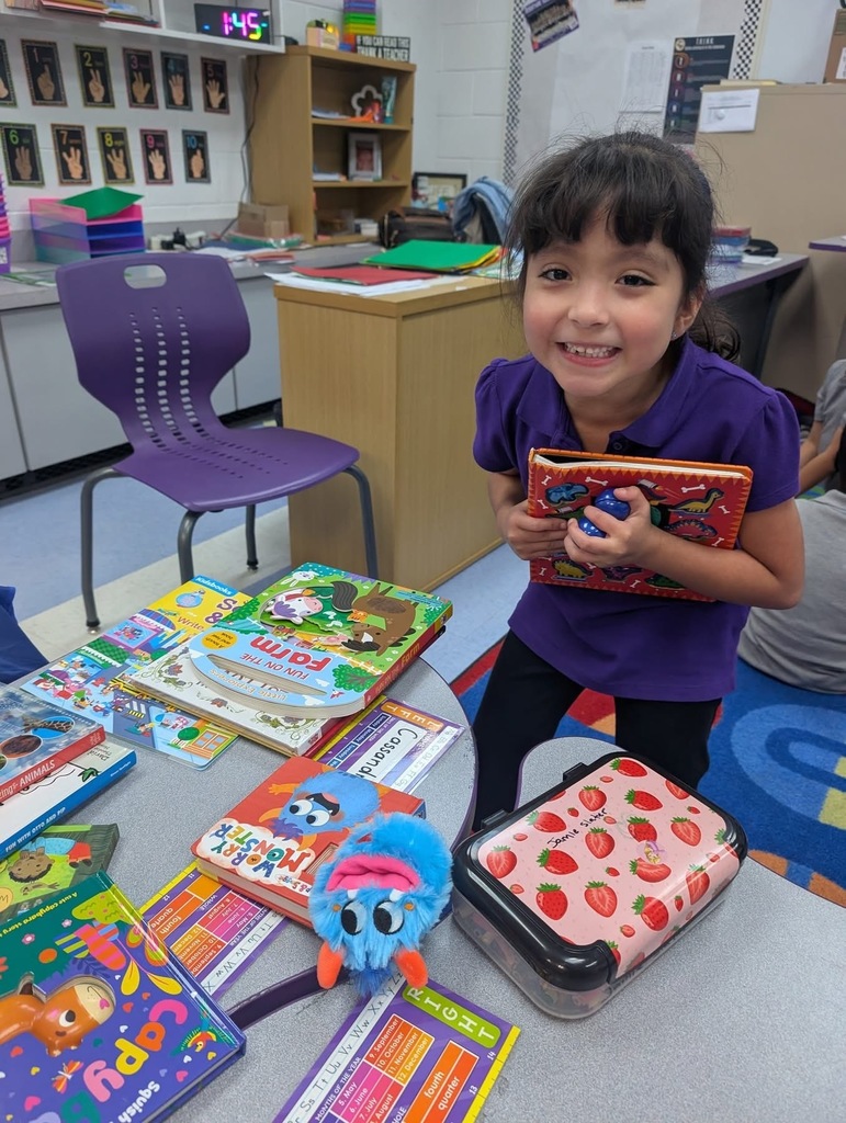 Girl student holding up her new book. 