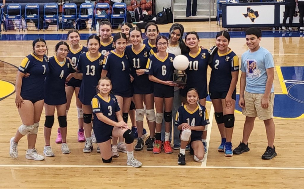 Photo of EKIS volleyball players celebrating a victory.