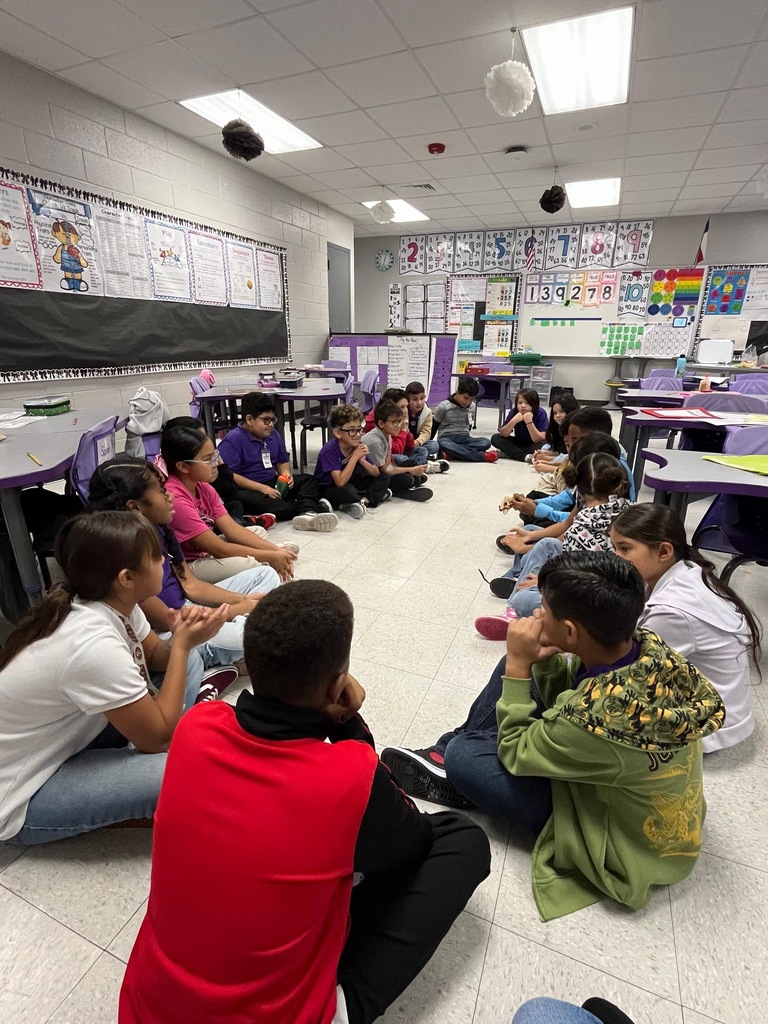 Students sitting in a circle. 