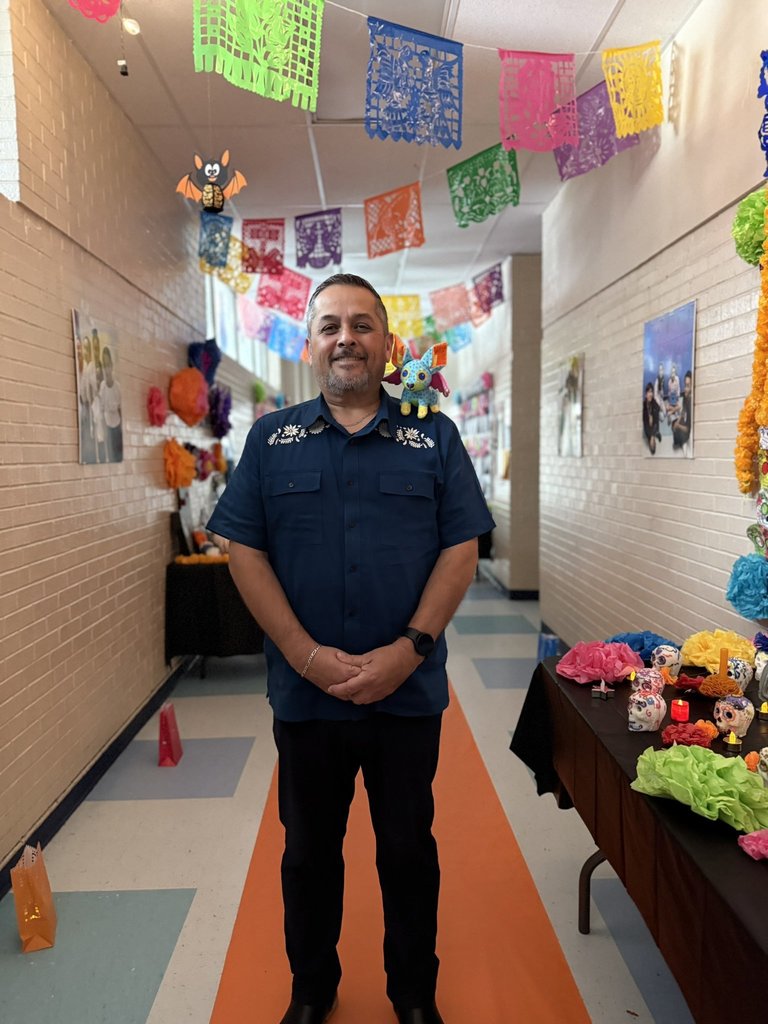 Mr. Puga in the 4th grade hallway decked for dia de los muertos.
