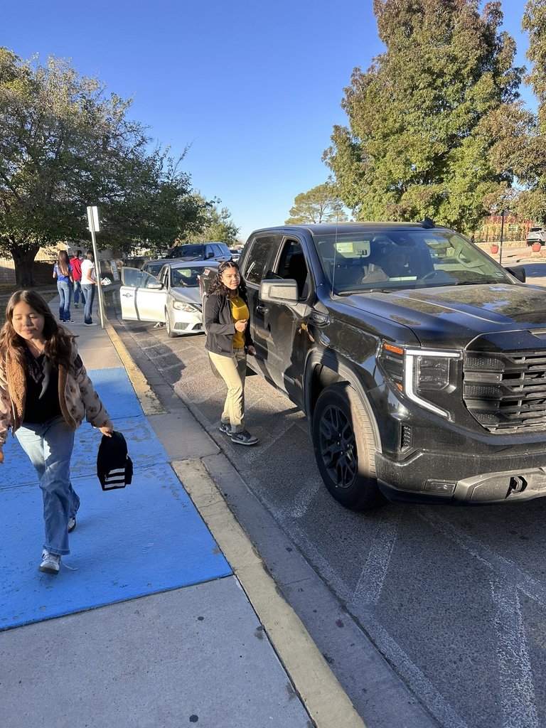 EKIS NJHS members distributing information to parents as they drop off their kids at school.