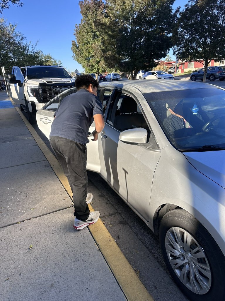 EKIS NJHS members distributing information to parents as they drop off their kids at school.