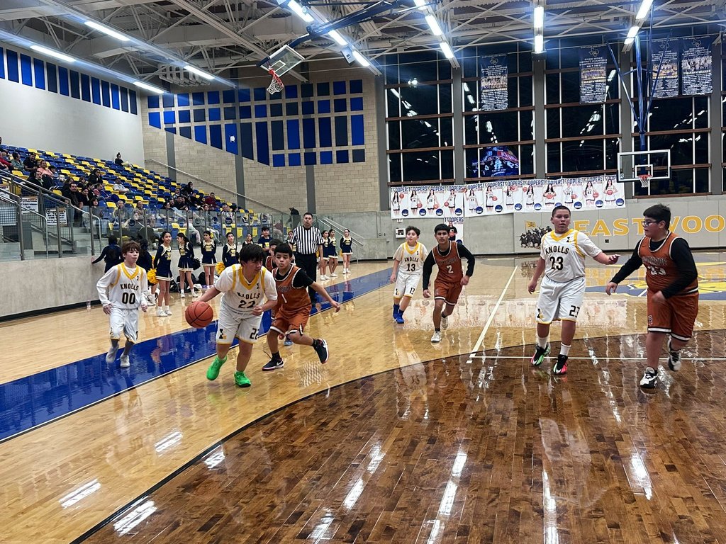 Photo of EKIS 7th grade basketball players at a game.