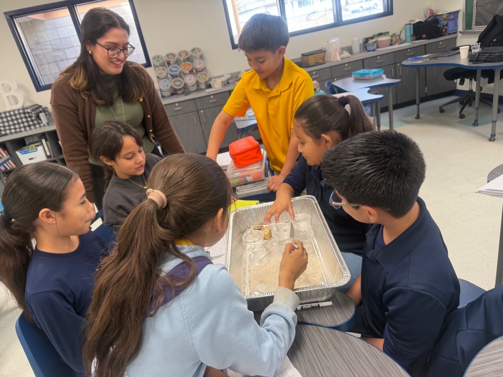 Photo of EKIS 4th grade students engaged in a science project.