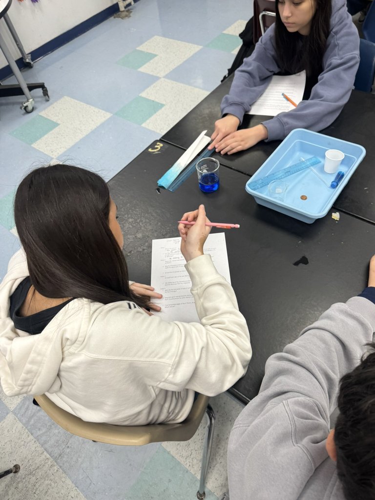 EKIS 8th graders engaged in a science project.