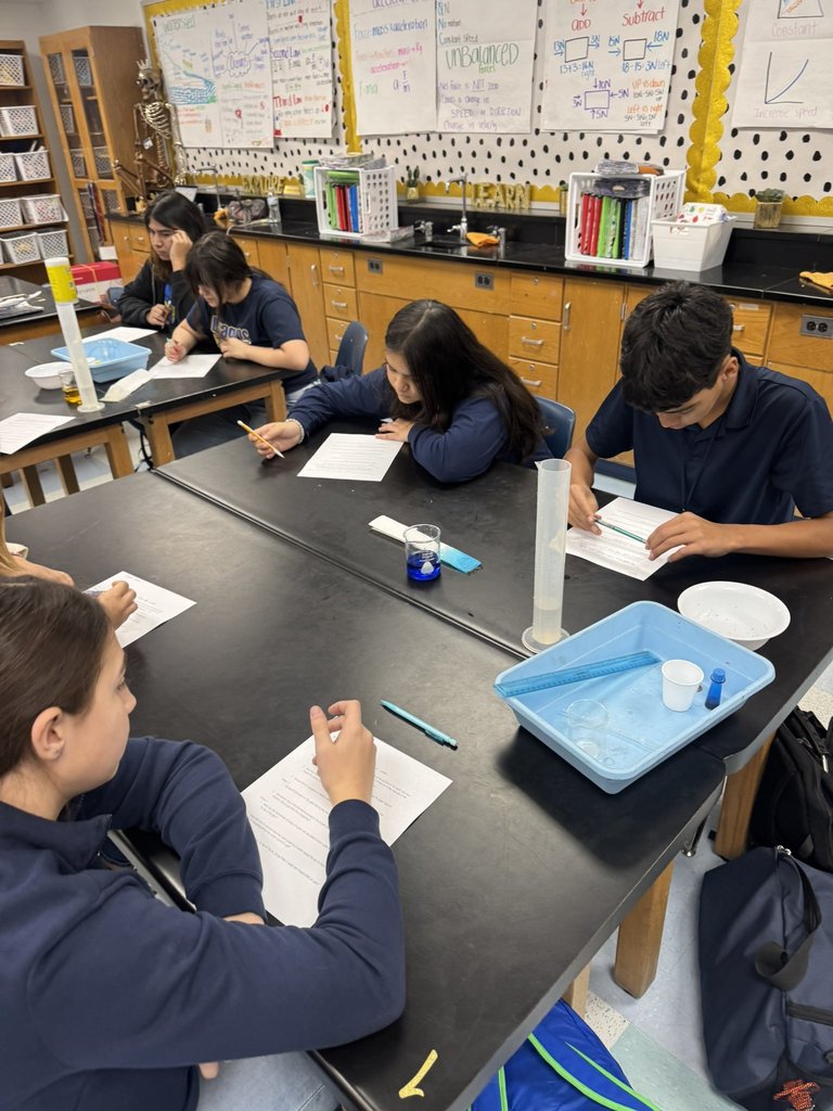 EKIS 8th graders engaged in a science project.