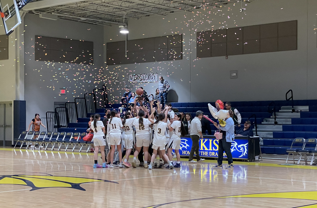 Photo of 7th grade girls basketball team at a game.