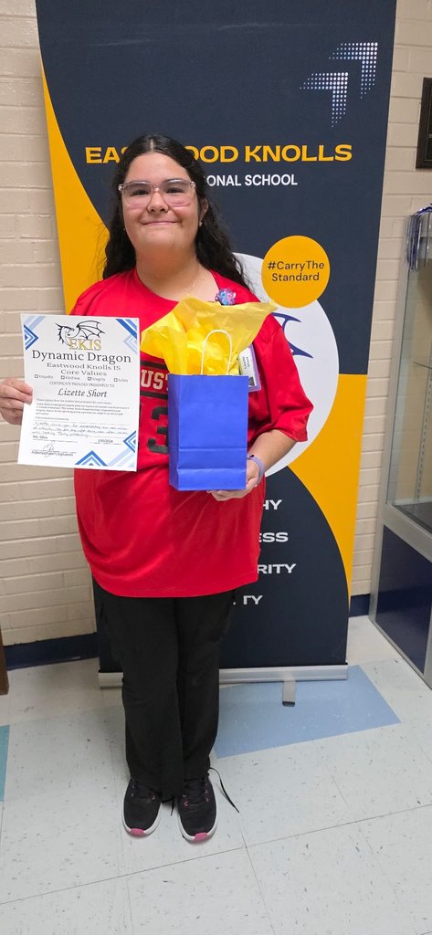 EKIS student receiving a Dynamic Dragon certificate.