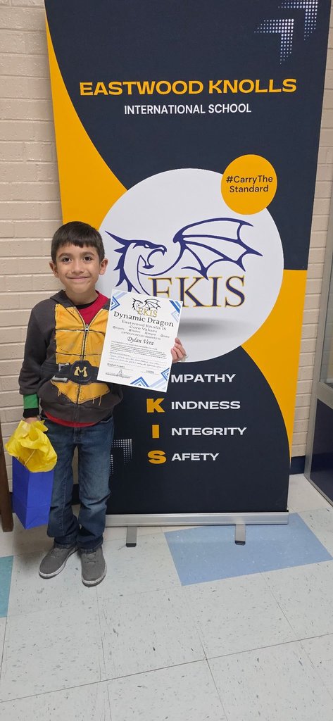 EKIS student receiving a Dynamic Dragon certificate.