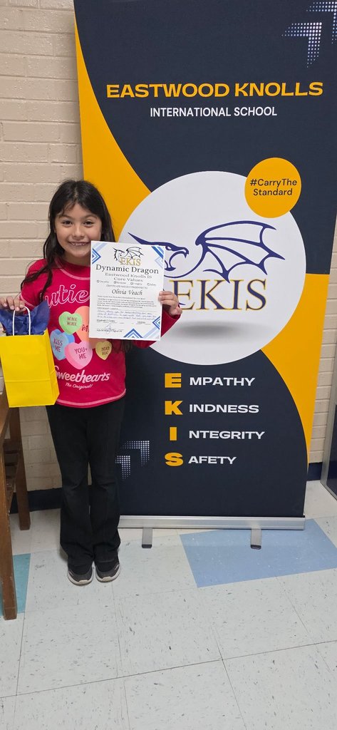 EKIS student receiving a Dynamic Dragon certificate.