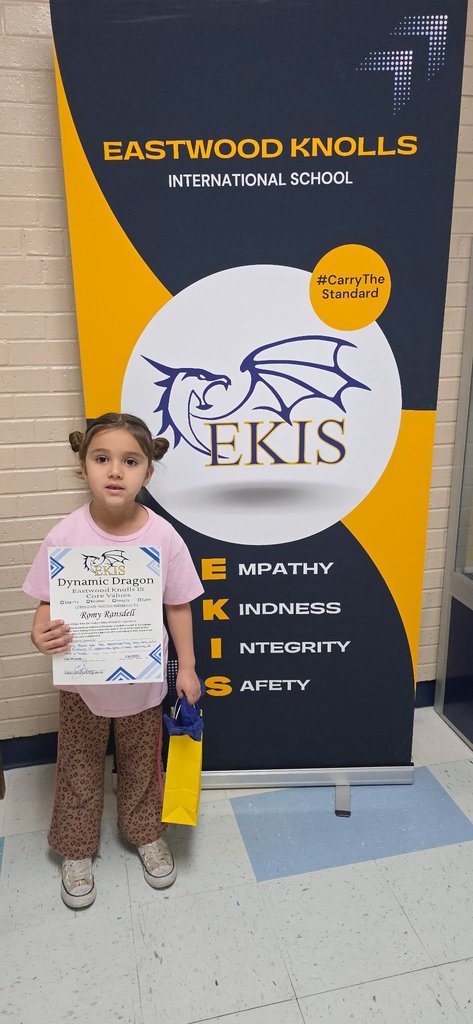 EKIS student receiving a Dynamic Dragon certificate.