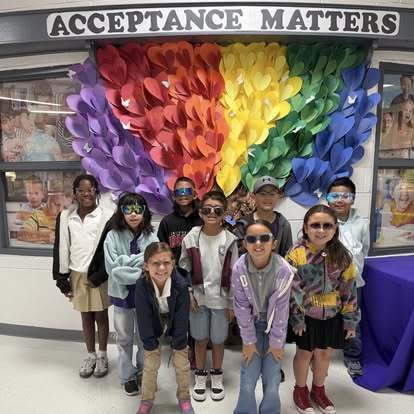 Students wearing sunglasses for Autism awareness week