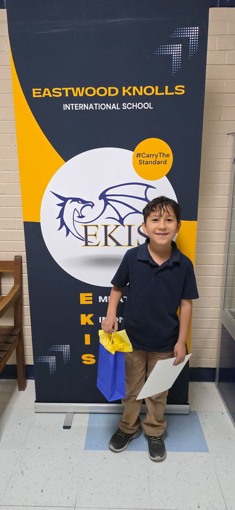 EKIS student receiving a Dynamic Dragon Certificate.