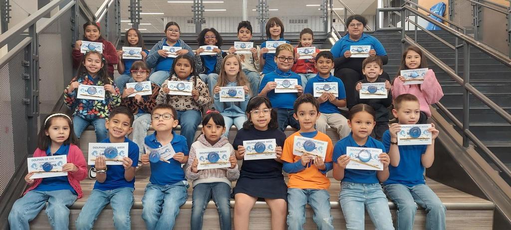 Students from Dolphin Terrace proudly displayed their awards and certificates while gathered together on the school staircase for a special recognition celebration. Smiling faces and proud accomplishments filled the photo as students showcased their hard work, positive character, and academic achievements. This moment reflects the supportive learning environment at Dolphin Terrace, where students are encouraged to grow with confidence, strive for excellence, and celebrate one another’s success.