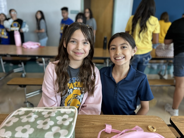 two girls posing at table